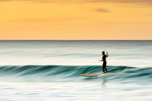 Surfing at sunset - Kirra, Gold Coast.