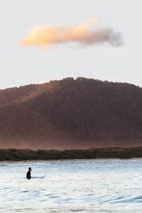 Surfing at sunset at Diamond Head, NSW.